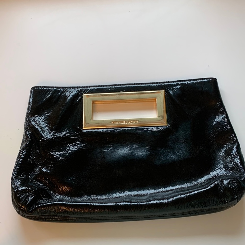 Michael Kors black clatch with golden handle. 8”*13”